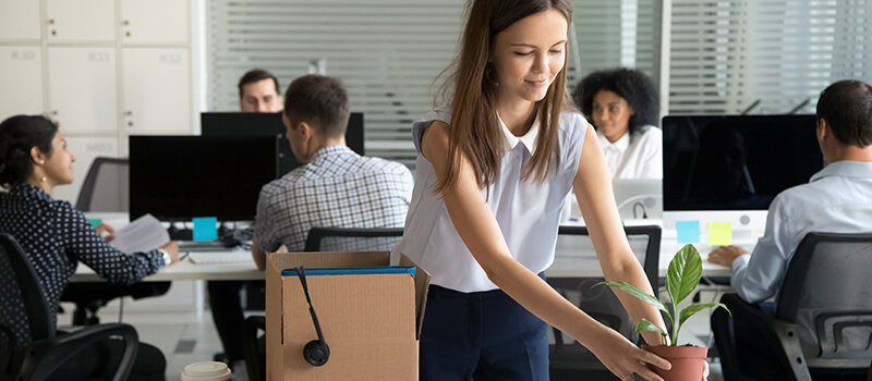 woman unpacking box on desk