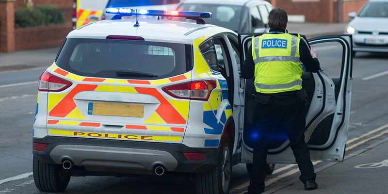 Police officer next to police car