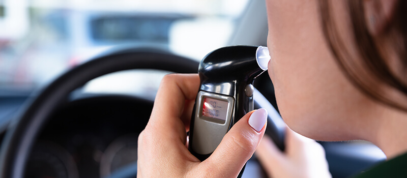 blowing into breathalyser