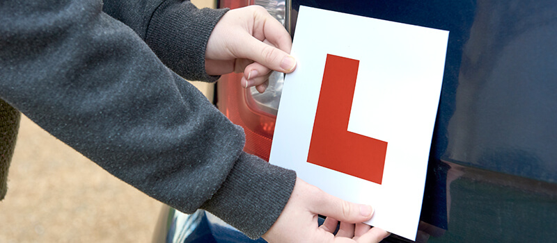 putting l plate on car