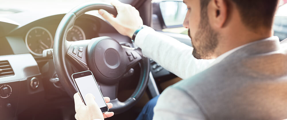 Man using mobile phone while driving