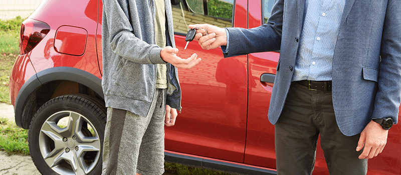 handing car keys to son