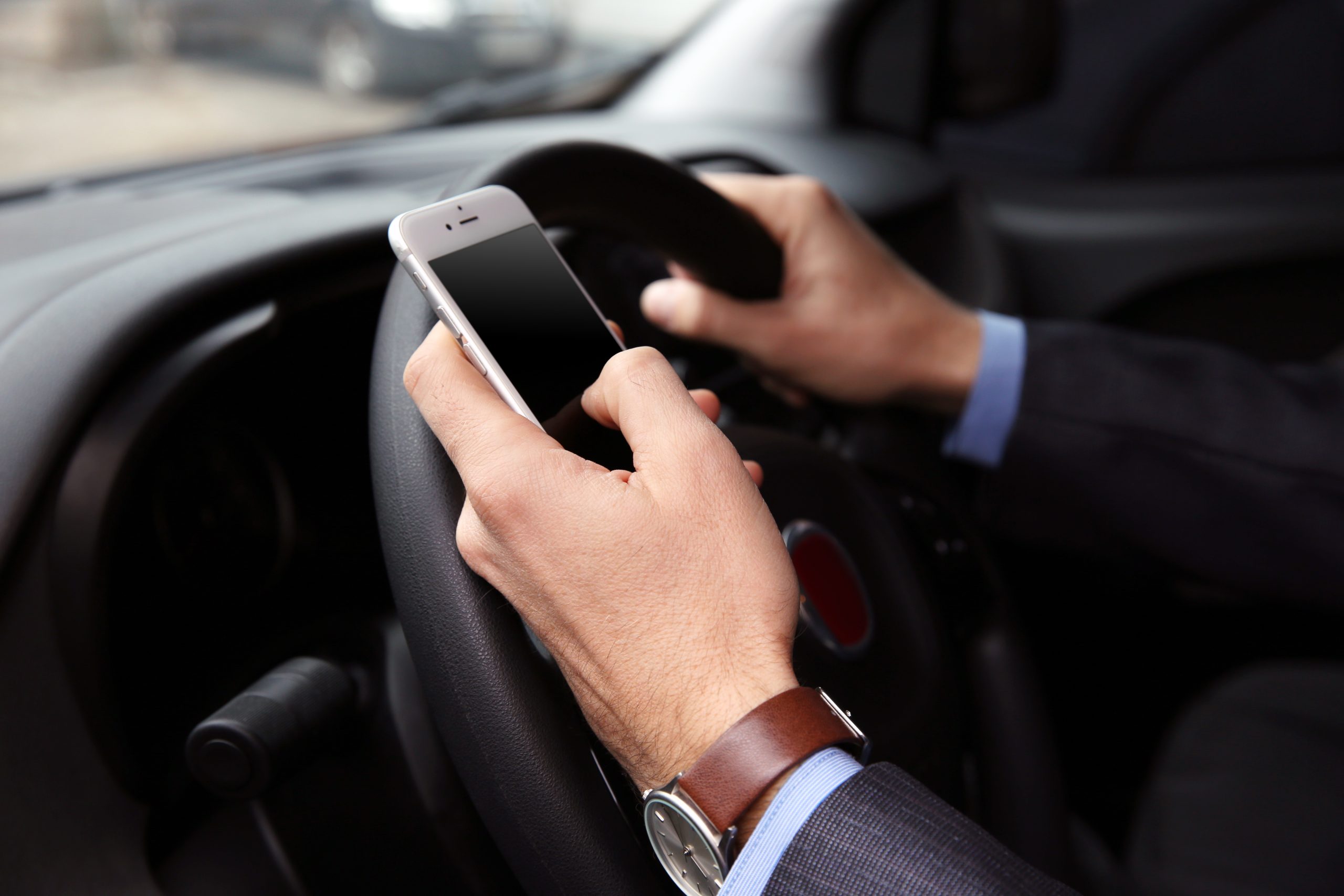 male driver using his phone whilst driving