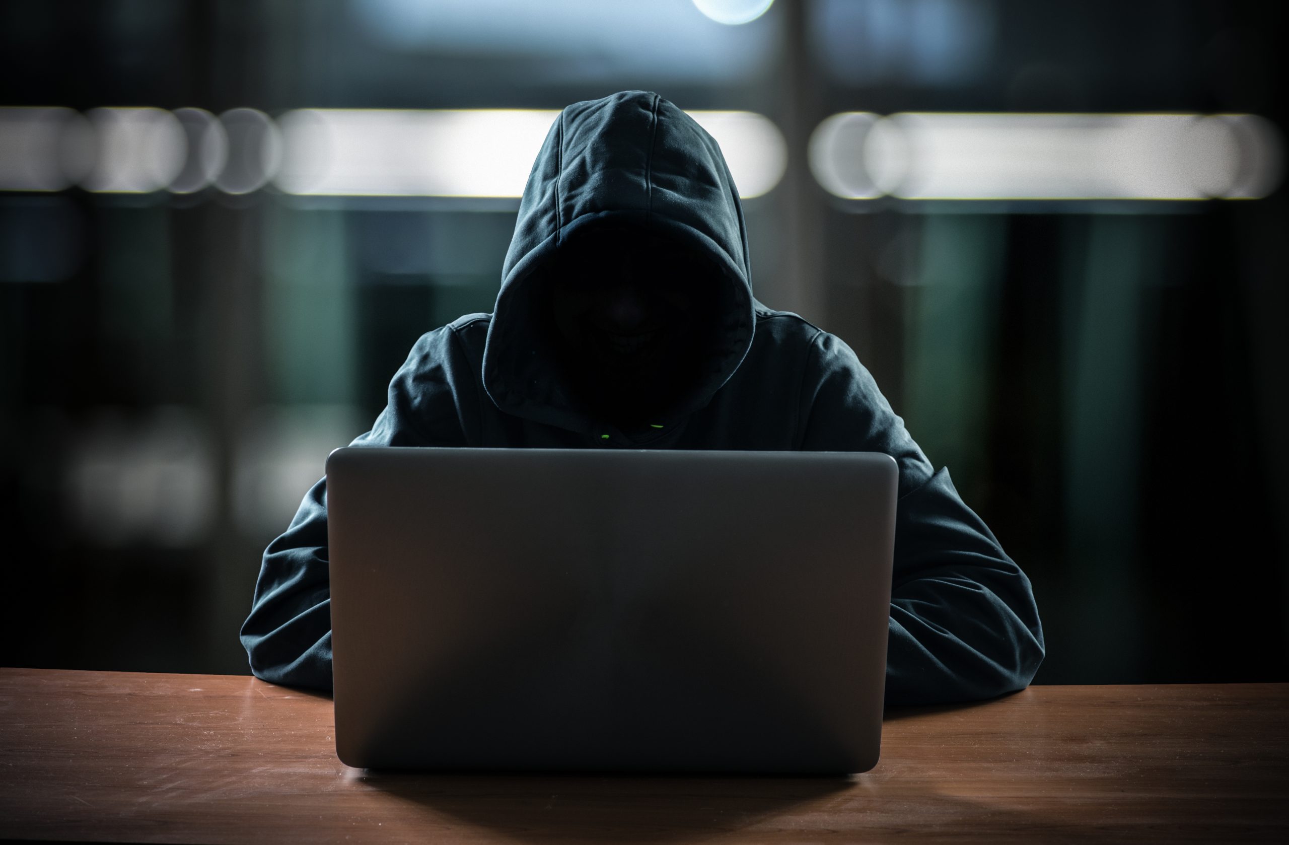 computer scammer on a laptop
