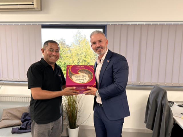 Anthony Johnson and driving instructor with a thank you cake