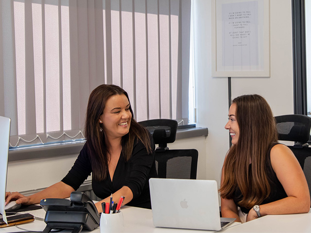Two driveJohnson's staff members smiling together