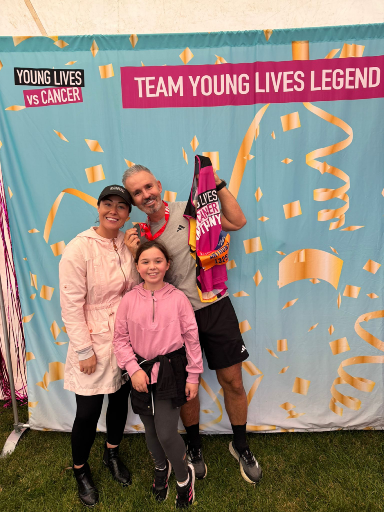 Carla, Freya and Anthony at the Young Lives Vs Cancer team backdrop