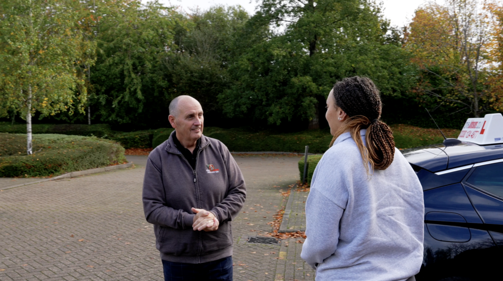 Driving instructor talking to their pupil
