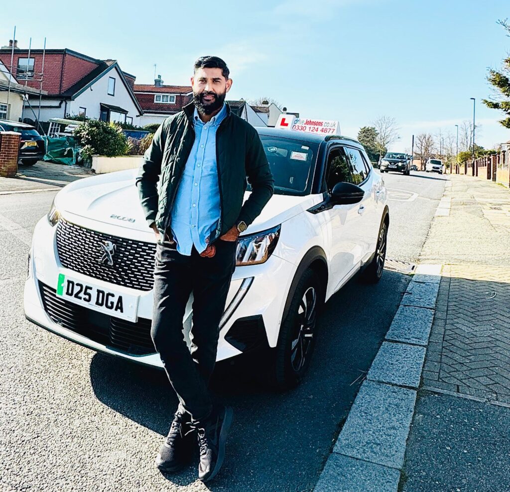 Nazmul Islam next to his driveJohnson's vehicle
