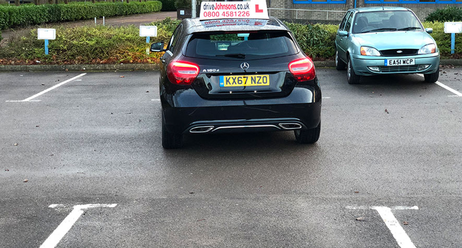 Car reversing into a bay