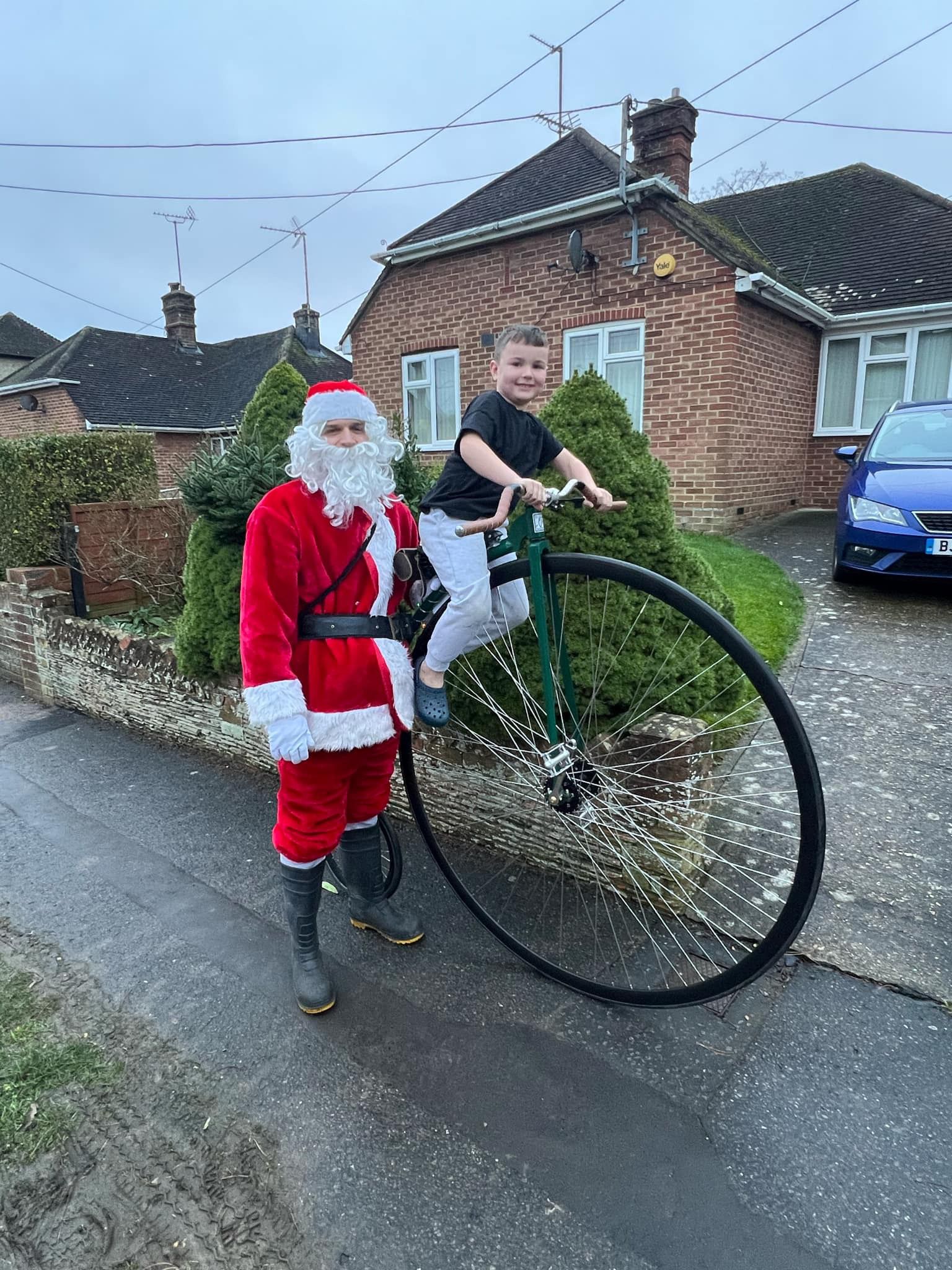 Charlie with his son on a penny farthing