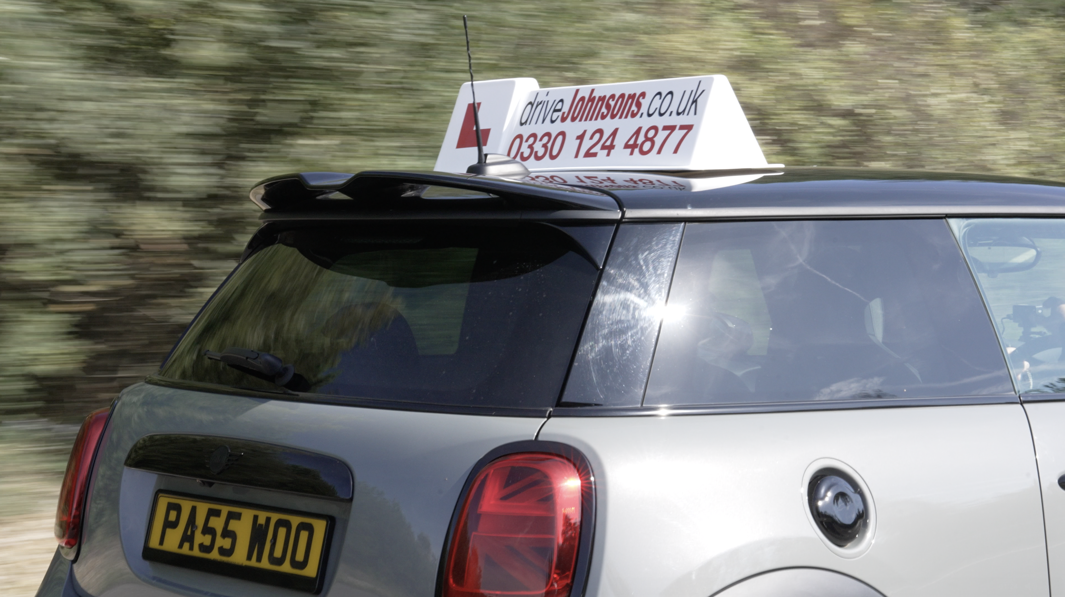Mini driving with driveJohnson's roof sign