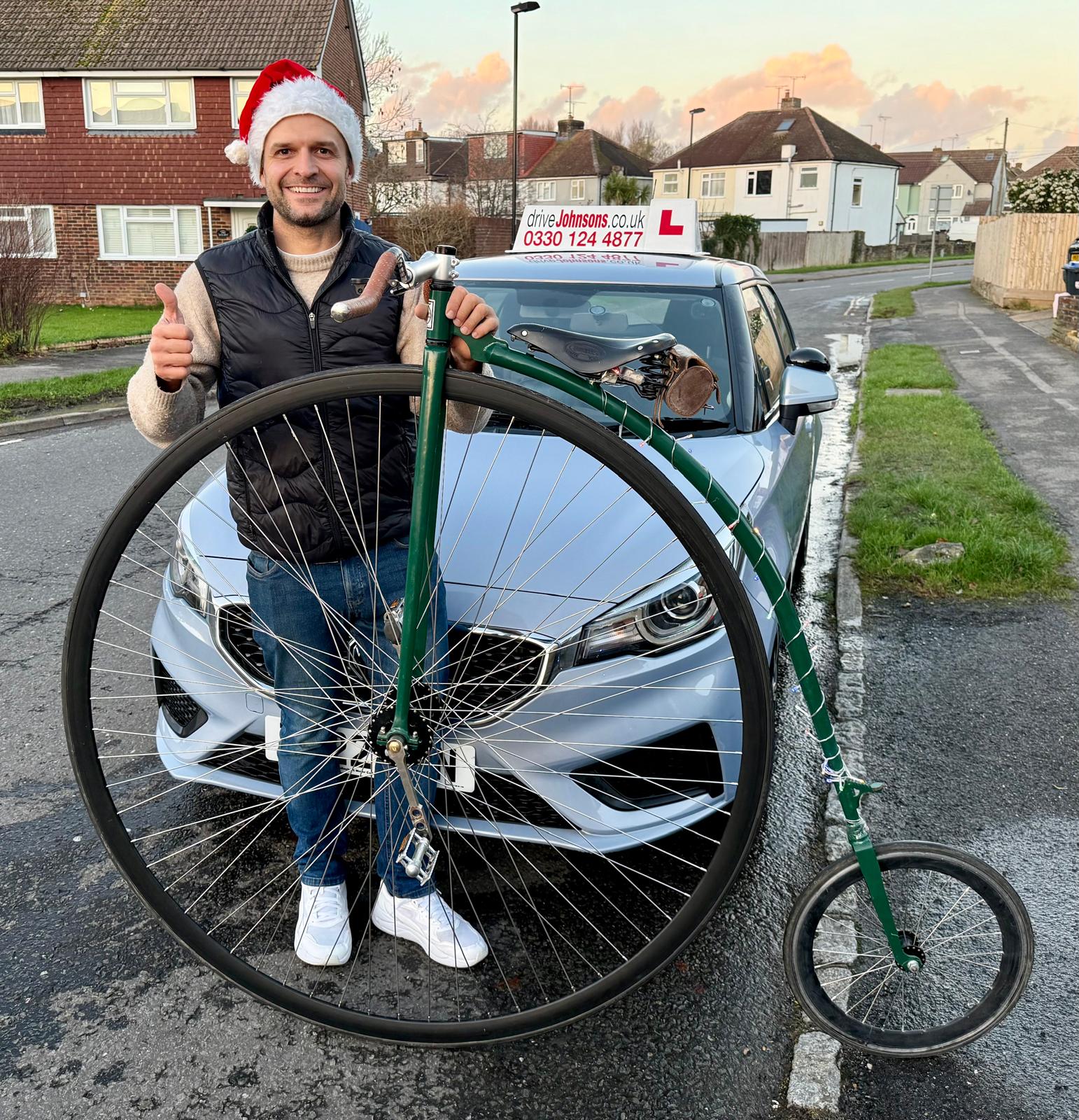 Charlie Burrell with a penny farthing and driveJohnson's car