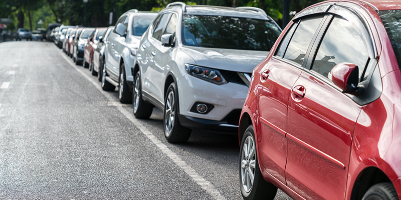 A line of cars parked along a street