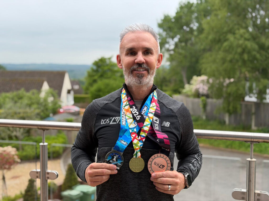 Anthony with his three marathon medals