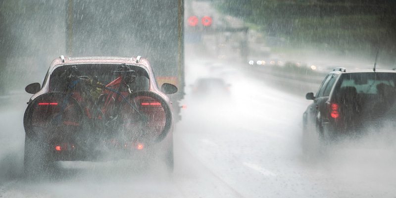 Vehicles driving on dual carriageway in the rain