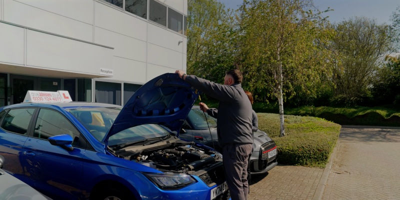 Learner opening bonnet on learner car