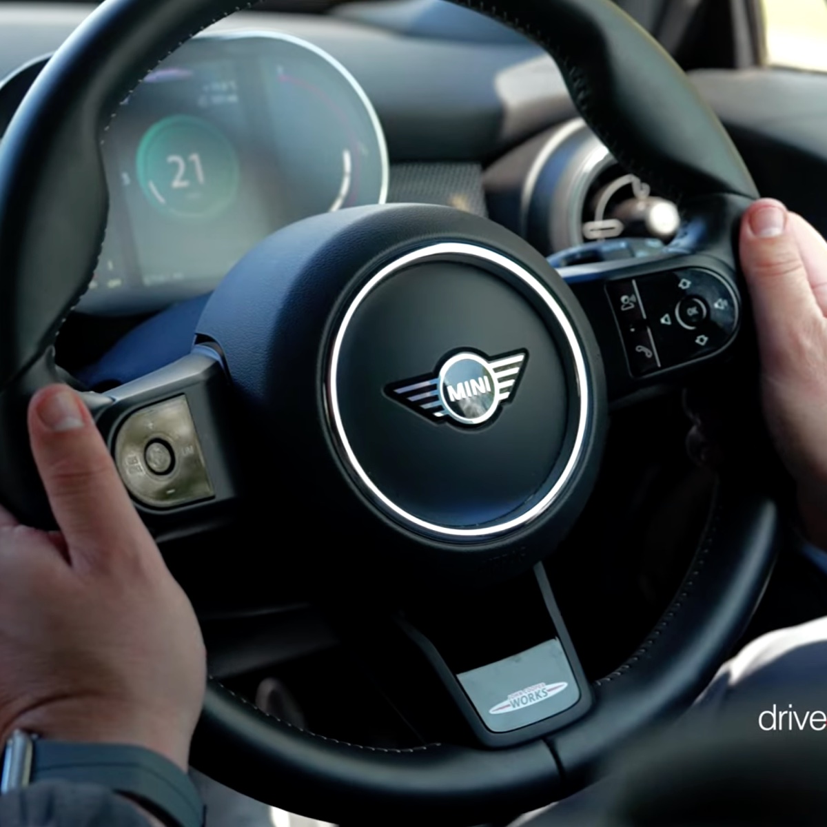 Hands gripping a steering wheel