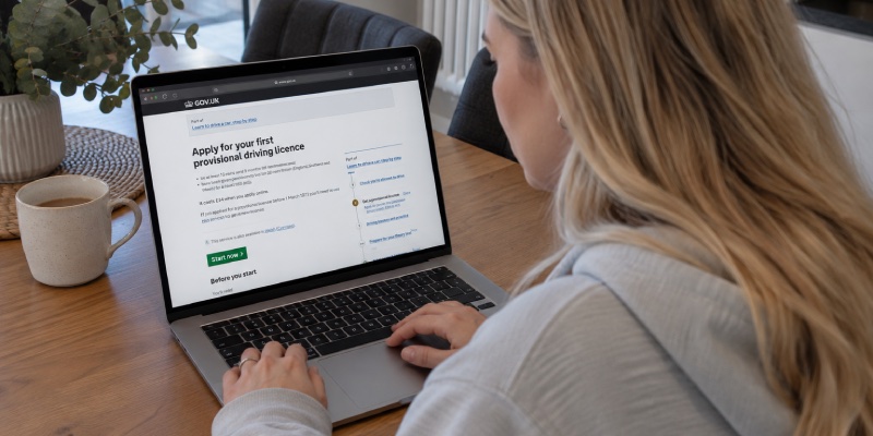 Girl on a laptop starting a driving licence application