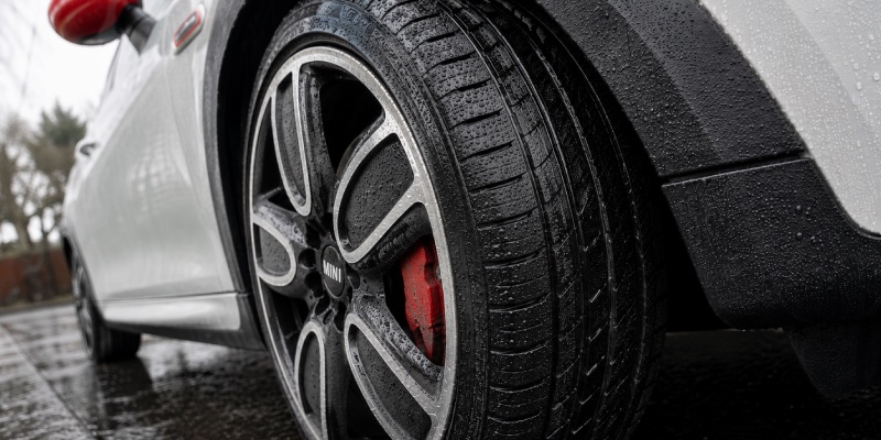 Close up of a Mini Cooper, showing the tyre is wet