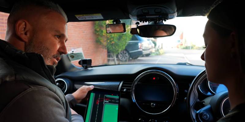Instructor and learner discussing turning right with diagram on a tablet